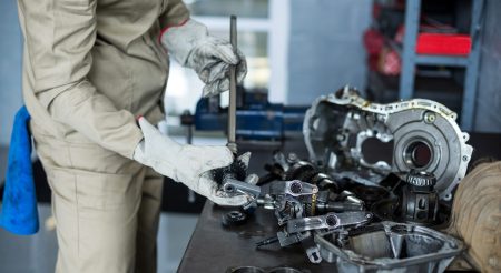 Mechanic checking a car parts in repair shop