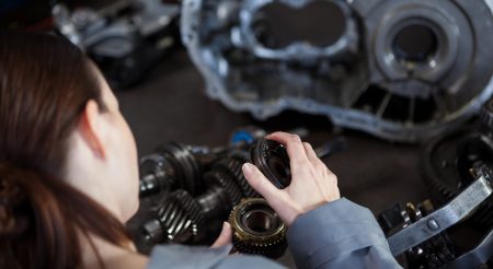 Female mechanic fixing gear
